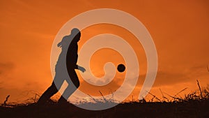 Man is training freestyle bal Hacky On Sunset Sack silhouette freestyle concept lifestyle . man playing soccer stuffing