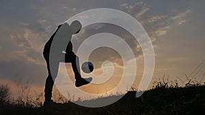 Man is training freestyle bal Hacky On Sunset Sack silhouette freestyle concept. man playing soccer stuffing a ball