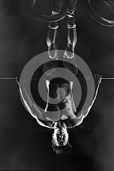 Man training gymnastics exercise on high bar in gym and fitness club