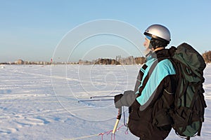 Man training with a kite  in winter, Ob reservoir, Novosibirsk, Russia