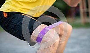 Man training knees using resistance band