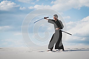 Man training martial arts in desert