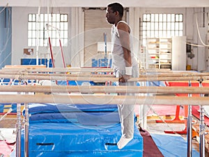 Man training on parallel bars