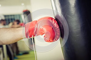 Man training on a punching bag in the gym