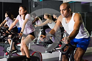 Man training on stationary bike in gym