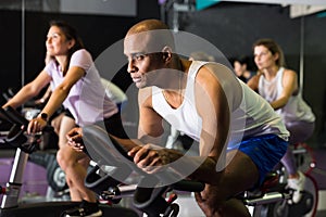 Man training on stationary bike in gym