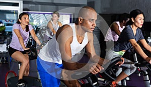 Man training on stationary bike in gym