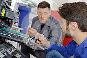 Man training to fix printer machine