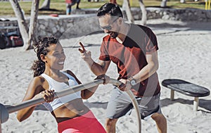 Man training woman on beach