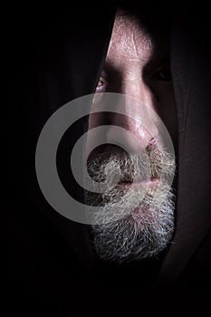 Man tramp with sackcloth and beard, face partially hidden 