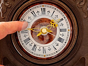 A man translates the clock hands. Time stop concept