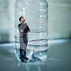 Man trapped inside plastic bottle. Plastic free concept