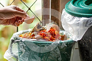 Man trashing shell egg to garbage making compost photo