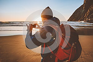 Man travel with backpack taking photo using smartphone camera blogger influencer outdoor