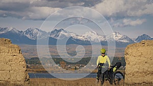 The man travel on mixed terrain cycle touring with bikepacking. The traveler journey with bicycle bags. Sport tourism