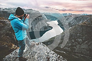 Man travel photographer taking photo landscape in Norway