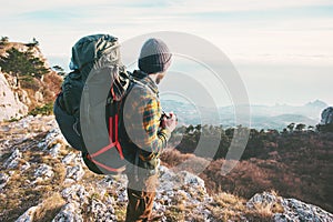 Man Traveler with backpack hiking mountains