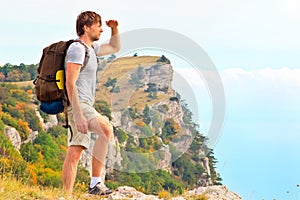 Man Traveler with backpack looking forward outdoor