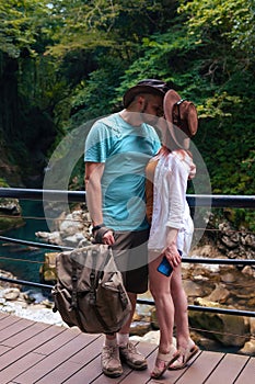 Man, traveler, backpacker, kissing woman, couple of people. Vertical photo. Tourism and recreation. Martvili canyon Georgia