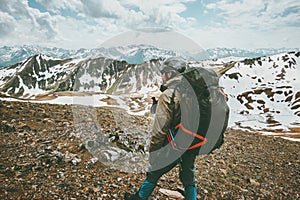 Man traveler with big backpack hiking in mountains