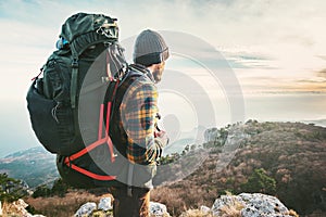 Man Traveler with big backpack hiking mountains expedition