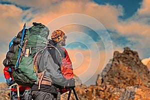 Man Traveler with big backpack mountaineering Travel Lifestyle concept lake and mountains on background, extreme vacations outdoor