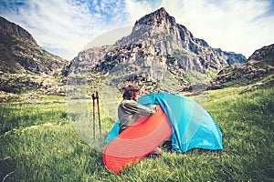 Man Traveler with camping equipment mat and tent outdoor Travel Lifestyle