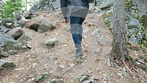 man traveler climbs rocks hiking wild northern forests trekking
