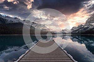 Man traveler enjoying the view of Spirit Island in Maligne Lake at Jasper National Park