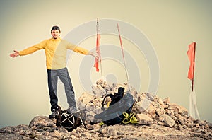 Man Traveler with hands raised on Mountain summit Traveling Mountaineering