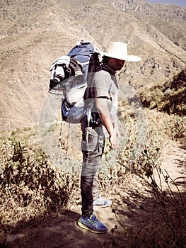 Man Traveler with hat and backpack hiking mountains Travel Lifestyle