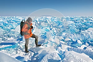 Man traveler on the ice field of Baikal lake