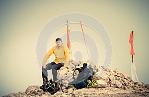 Man Traveler on Mountain summit with backpack Traveling Mountaineering