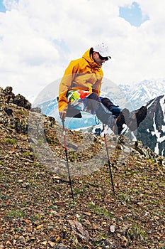 Man Traveler on mountain summit enjoying having fun doing gymnastics