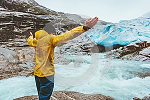 Man traveler raised hands enjoying landscape