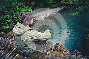 Man Traveler relaxing on wooden bridge