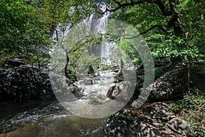 Man traveler is sightseeing at khlong lan waterfall in Kamphengphet