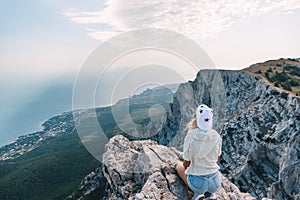 Man traveler sitting on mountain and looking at beautiful landscape and sea