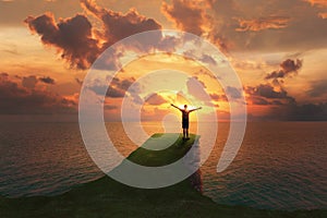 Man traveler standing on the top of a cliff