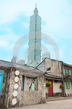 man traveler visiting in Taiwan, happy Tourist sightseeing in Si Si Nan Cun or Old Military Village against Taipei city, landmark