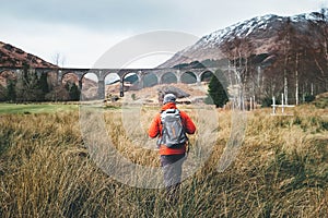 Man traveler walks neaar famous Glenfinnan viadukt in Scotland