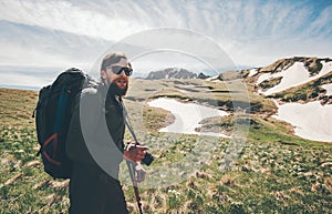 Man traveling with backpack hiking in mountains