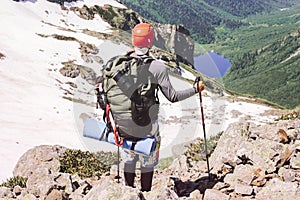 Man traveling with backpack hiking in mountains Travel Lifestyle