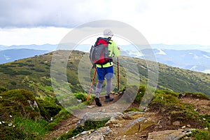 Man traveling with backpack hiking in mountains Travel Lifestyle success concept adventure active vacations outdoor