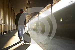 Man traveling with bag at train station