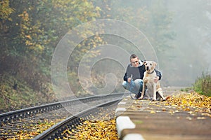 Man traveling with his dog by train