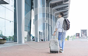 Man Traveller Arrived To Airport, Walking With Suitcase And Backpack Outdoors