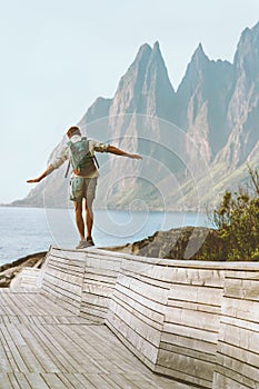 Man traveller exploring Norway traveling solo summer vacations active healthy lifestyle