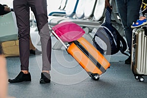 Man traveller with travel suitcase or luggage walking in airport