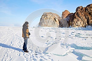 A man travels on the ice of the frozen Lake Baikal. Winter travel